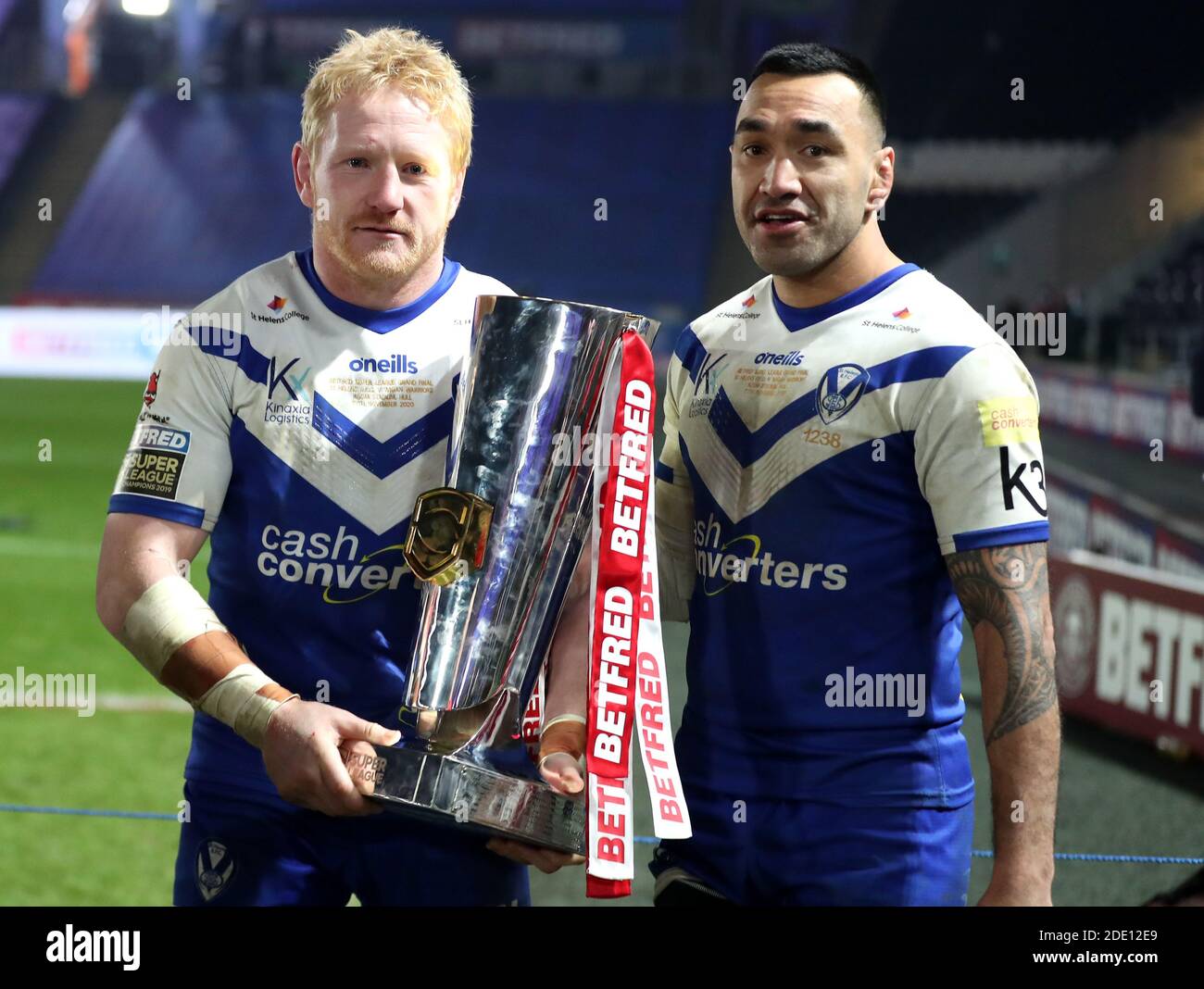 St Helens' James Graham left) and Zeb Taia celebrate with the trophy after winning the Betfred Super League Grand Final at the KCOM Stadium, Hull. Stock Photo