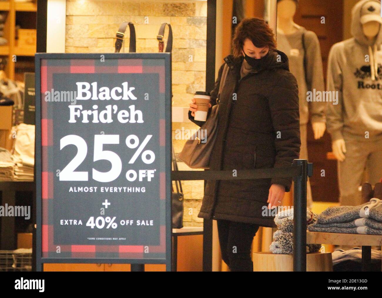 Vancouver, Canada. 27th Nov, 2020. A shopper checks on Black Friday deals at a shop in downtown Vancouver, British Columbia, Canada, on Nov. 27, 2020. Credit: Liang Sen/Xinhua/Alamy Live News Stock Photo