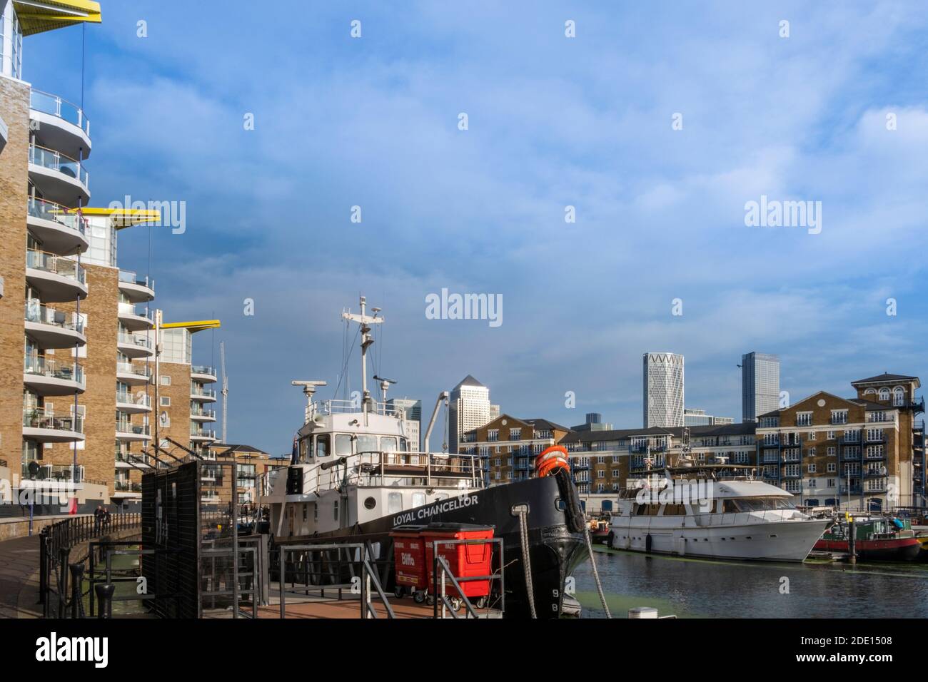 Boats moored in the marina next to modern residential apartments, Limehouse Basin, Regents Canal, Tower Hamlets, London, England, United Kingdom Stock Photo