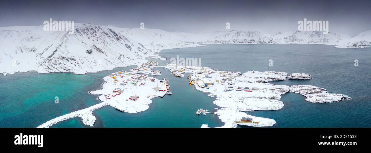 Aerial view of mountains and sea surrounding Sorvaer after a snow
