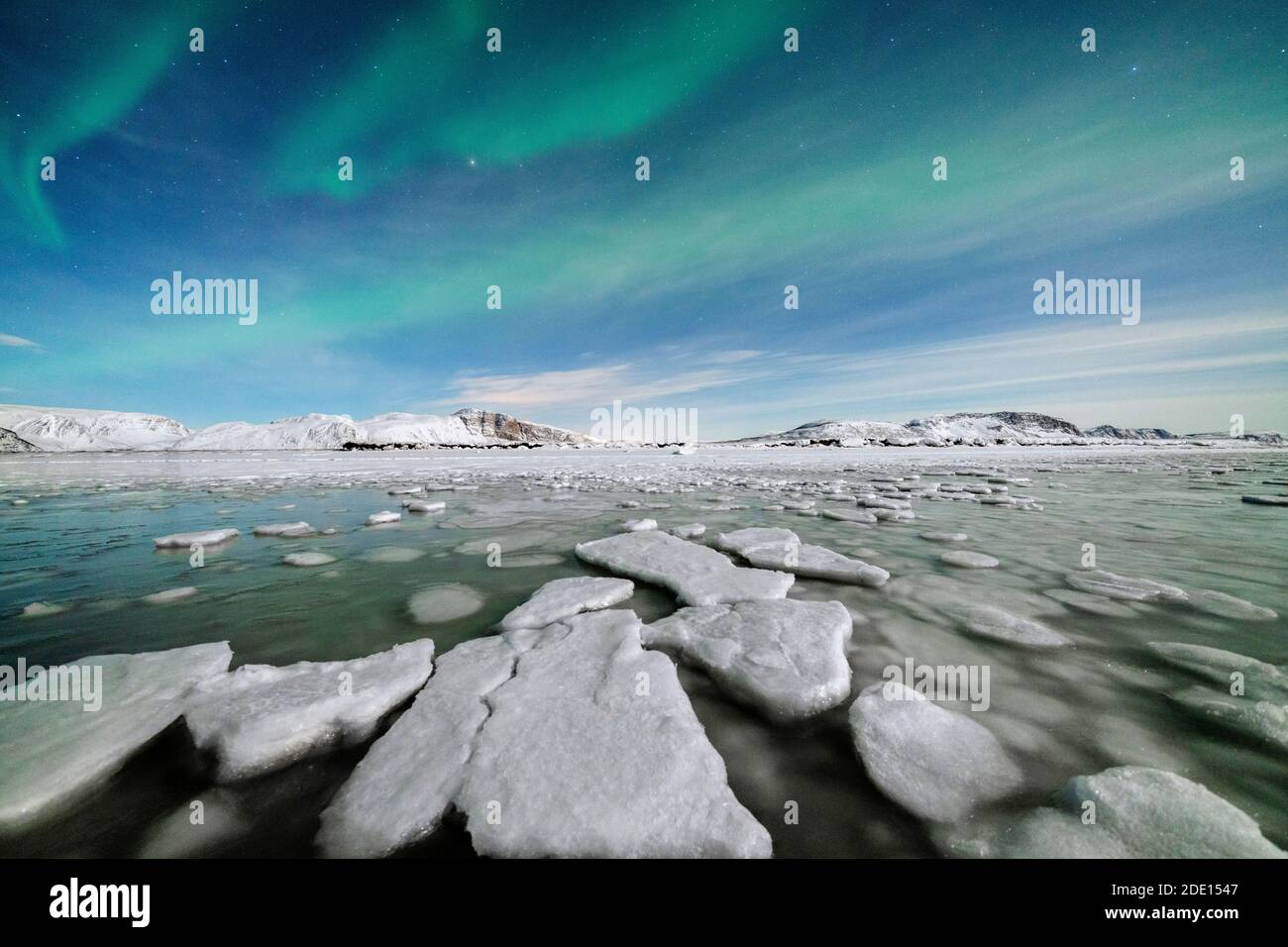 Ice blocks in the frozen Arctic sea lit by Northern Lights (Aurora Borealis), Tanamunningen Nature Reserve, Leirpollen, Troms og Finnmark, Norway Stock Photo