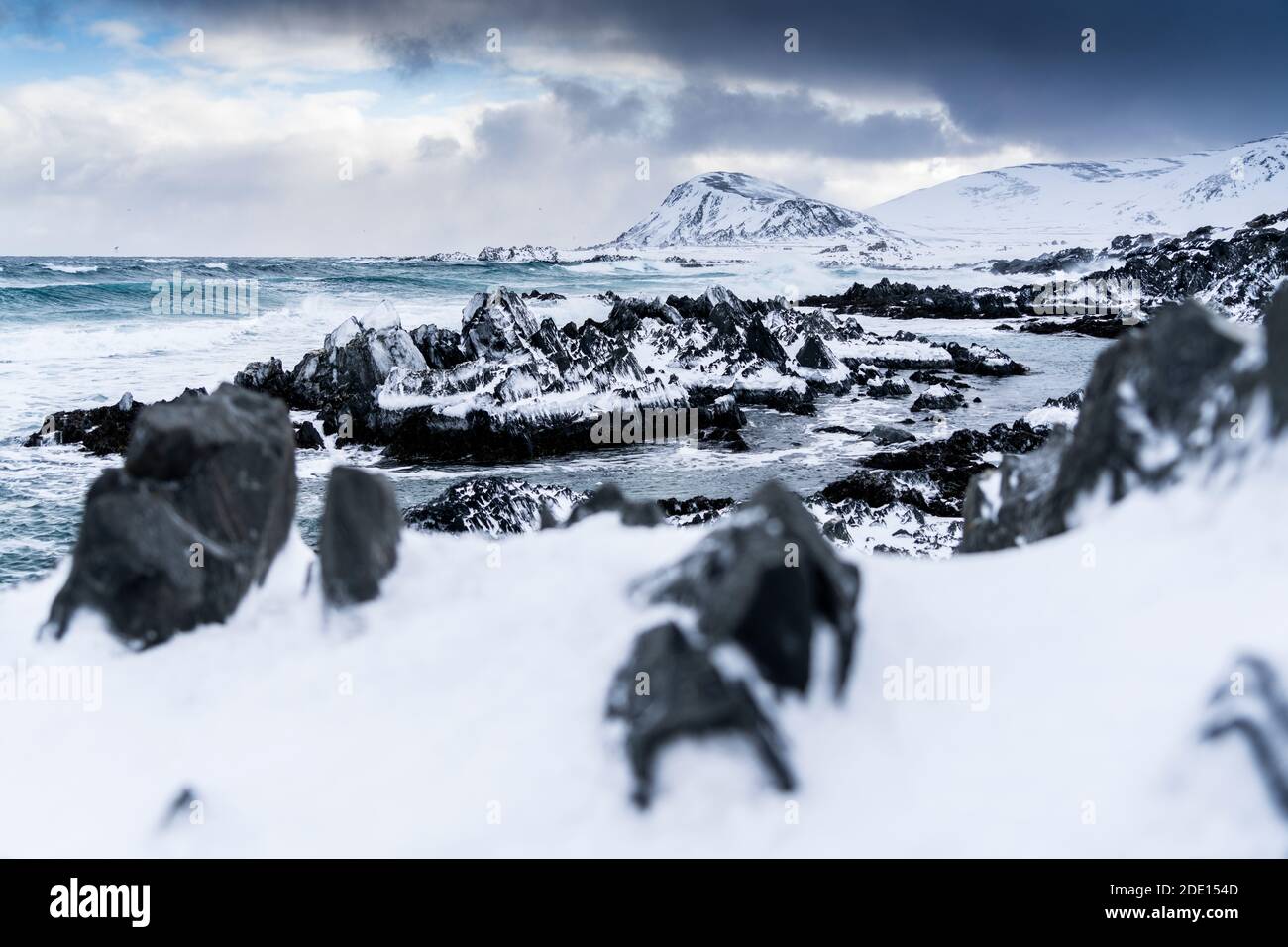 Cliffs covered with snow on coastline of the cold Barents Sea, Sandfjorden, Arctic Ocean, Varanger Peninsula, Finnmark, Norway, Scandinavia, Europe Stock Photo