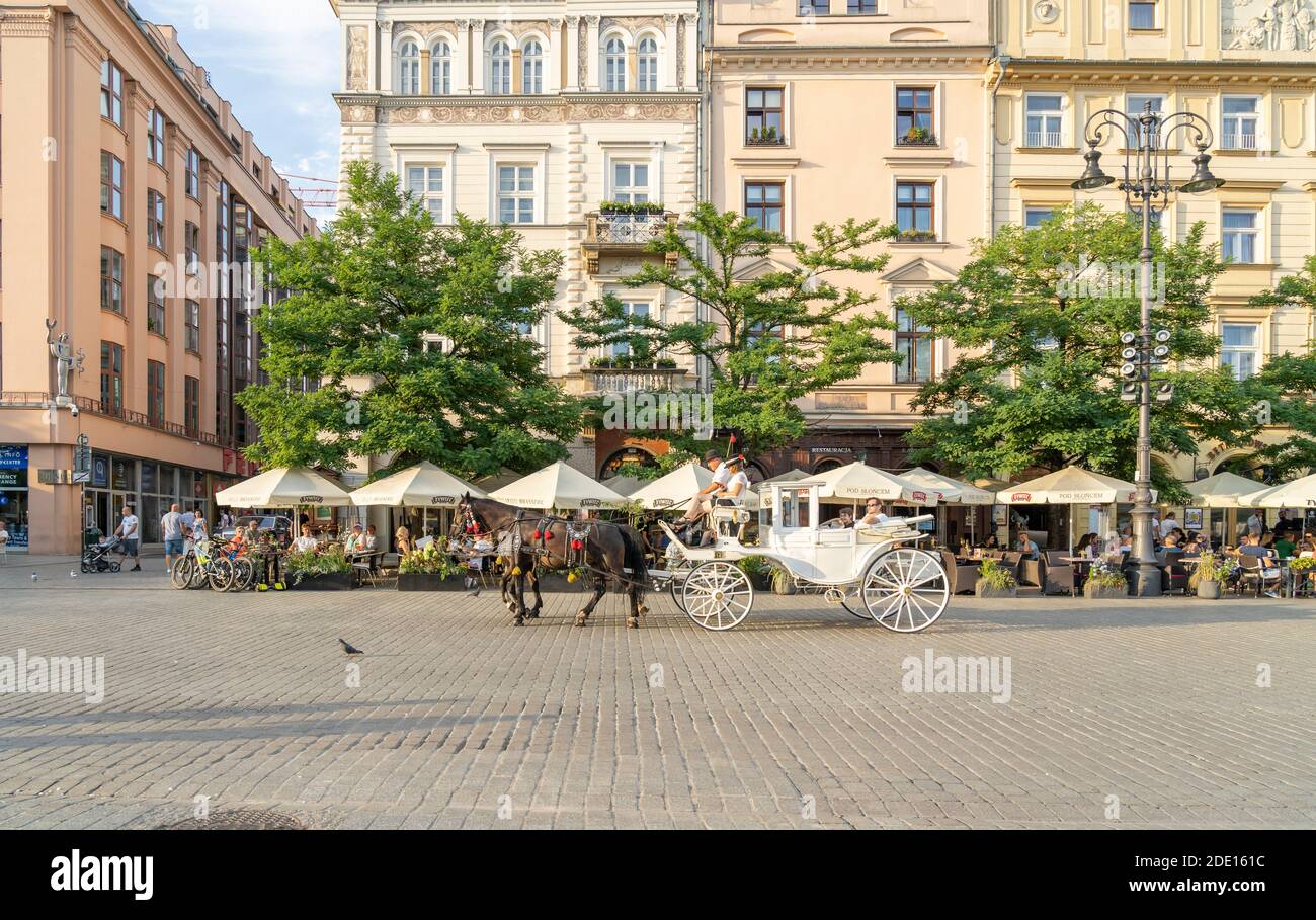 Horse and carrriage taxi in The Old town Square, UNESCO World Heritage Site, Krakow, Poland, Europe Stock Photo