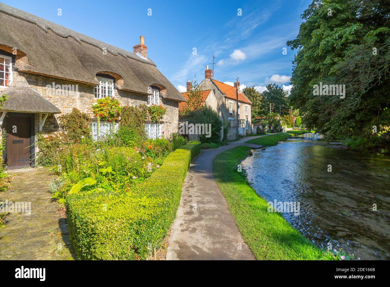 View of riverside cottages and Thornton Beck, Thornton Dale, North Yorkshire, England, United Kingdom, Europe Stock Photo