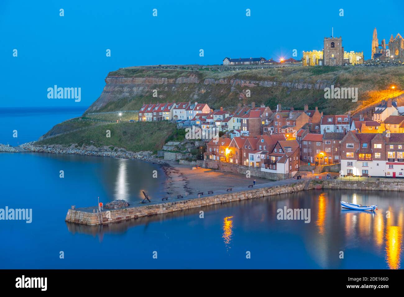 View of St. Mary's Church and Whitby Abbey from across River Esk at dusk, Whitby, Yorkshire, England, United Kingdom, Europe Stock Photo