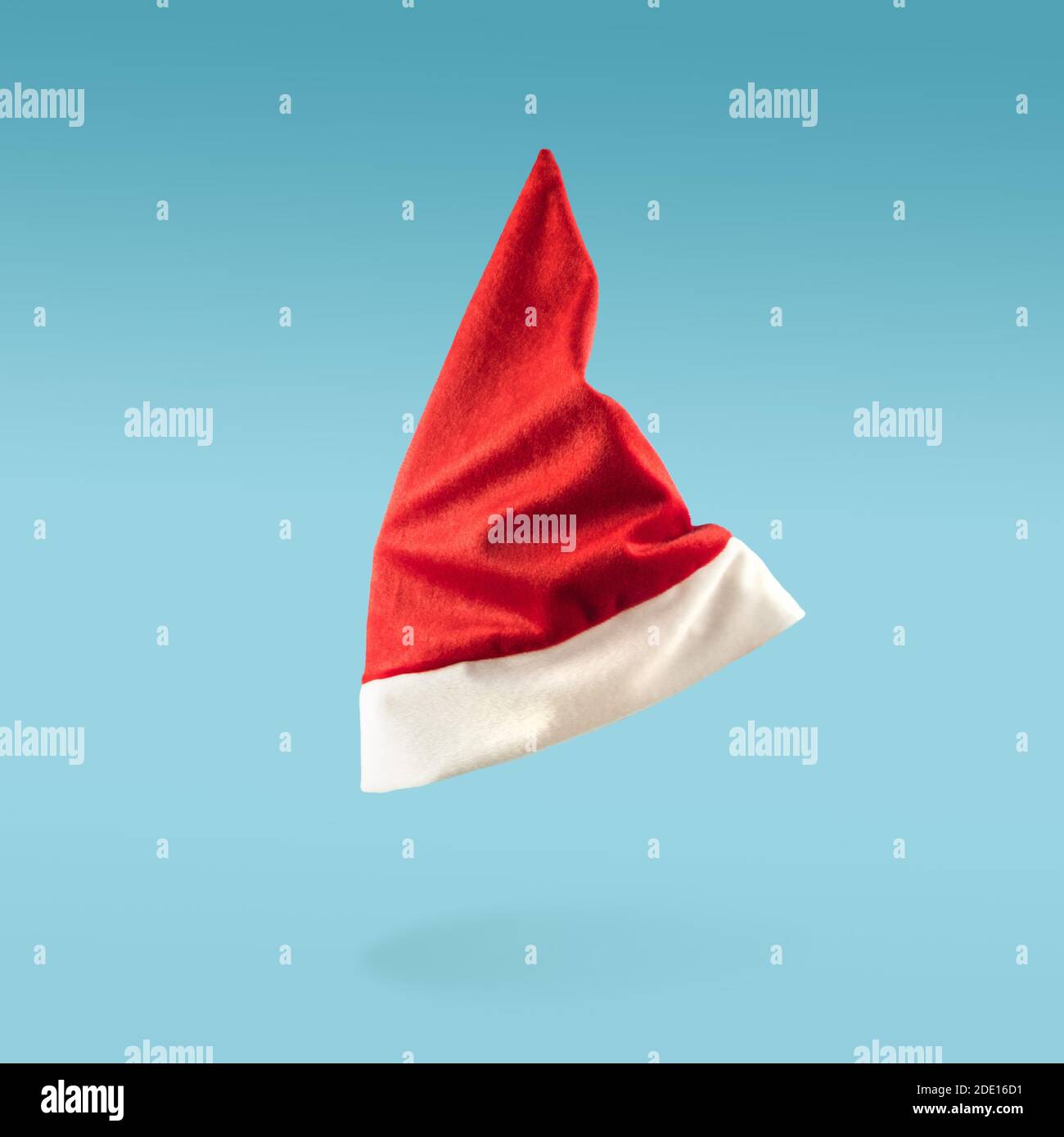 Santa Claus hat levitation on blue background. Minimal Christmas ...
