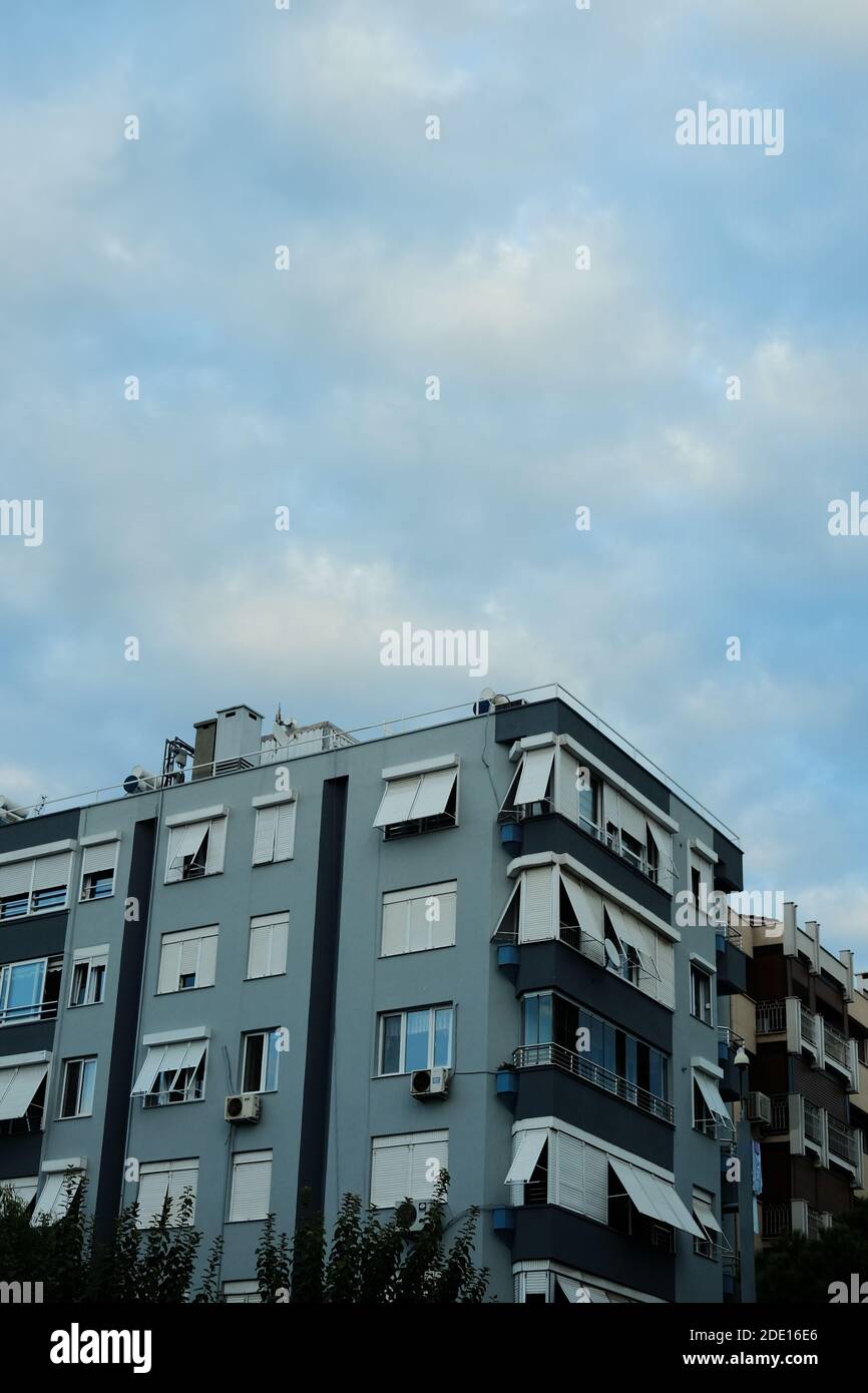 A vertical shot of beautiful buildings under a blue and cloudy sky ...