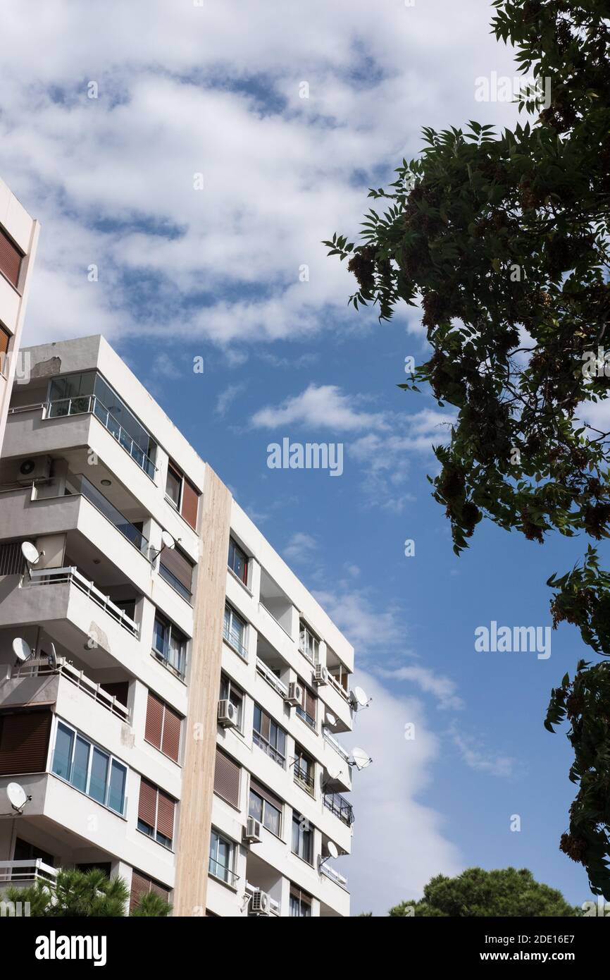 A vertical shot of beautiful buildings under a blue and cloudy sky ...