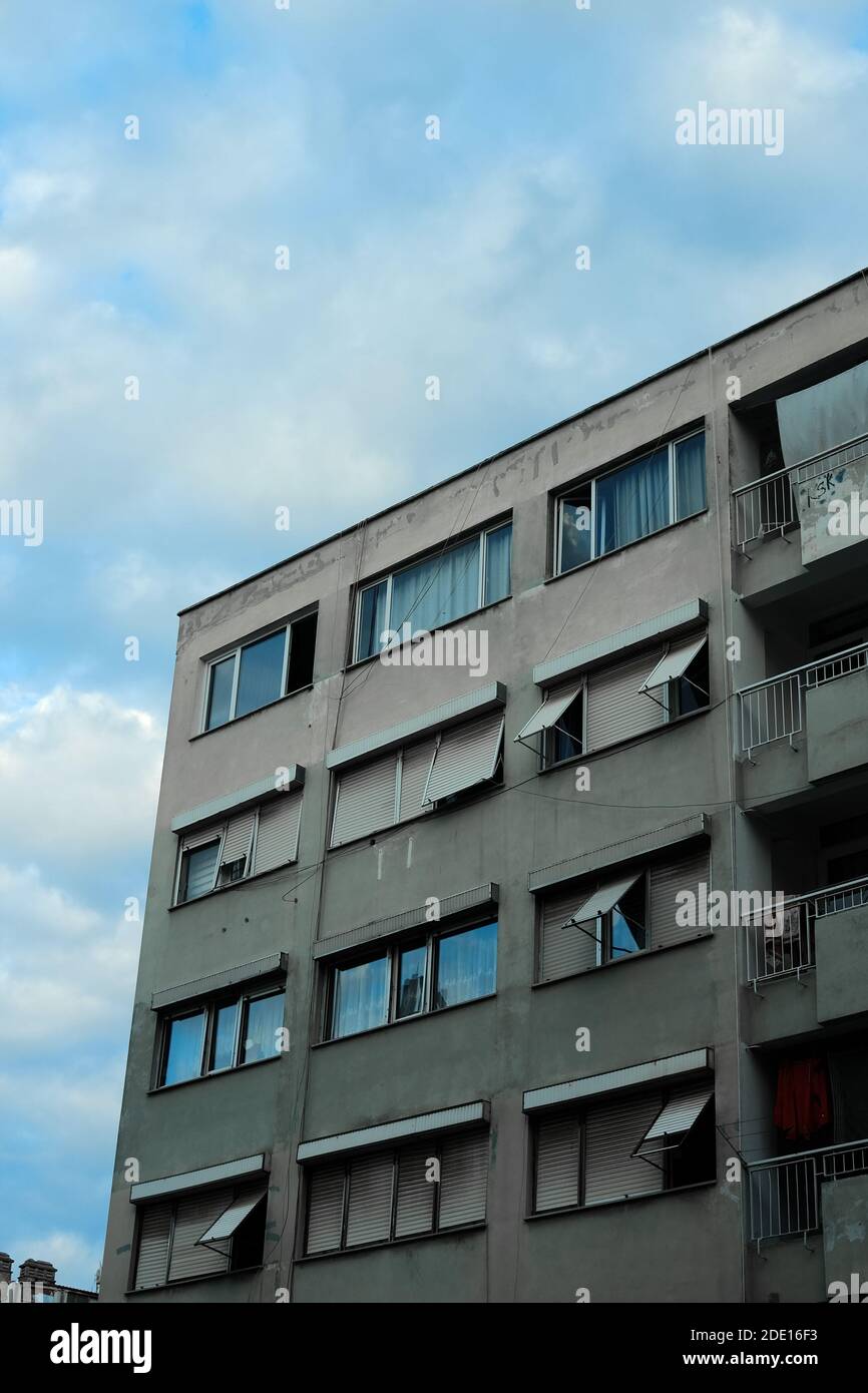A vertical shot of beautiful buildings under a blue and cloudy sky ...