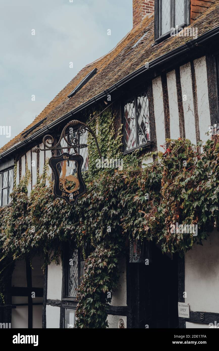 Rye, UK - October 10, 2020: Sign by the entrance to The Mermaid Inn, a historic hotel in Rye with cellars dating from 1156 and the building rebuilt in Stock Photo