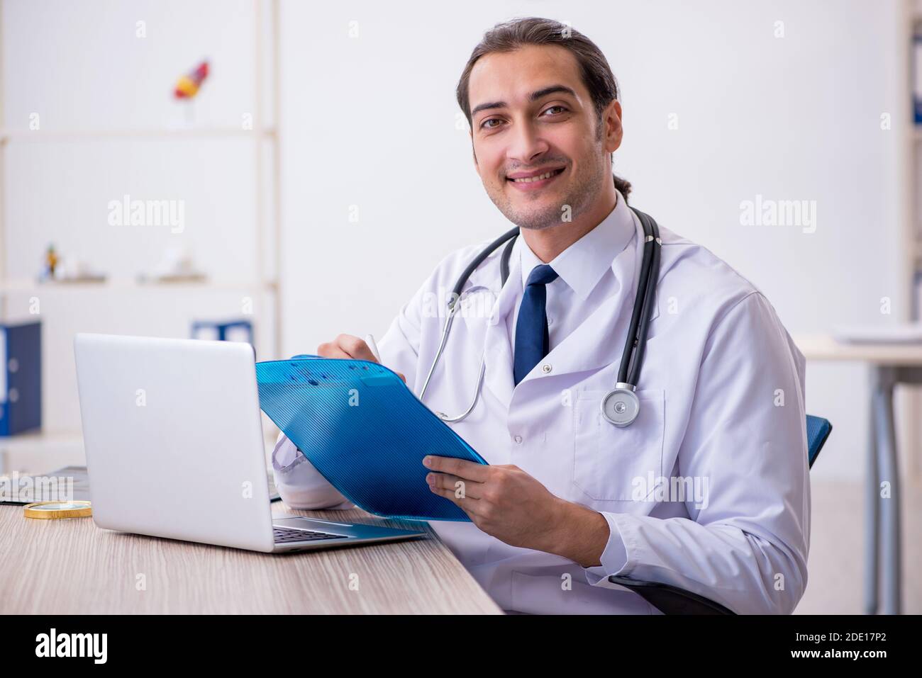 Young doctor taking notes at the hospital Stock Photo - Alamy