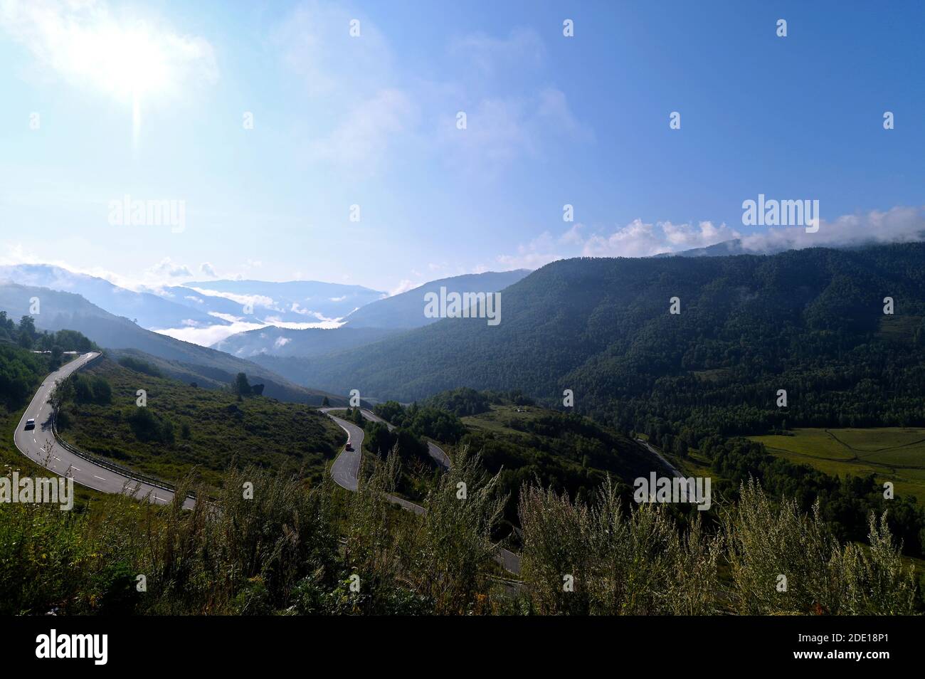 View of the Altai Mountain range and highway enroute to Hemu Village from Kanas Lake, Northern Xinjiang, China Stock Photo