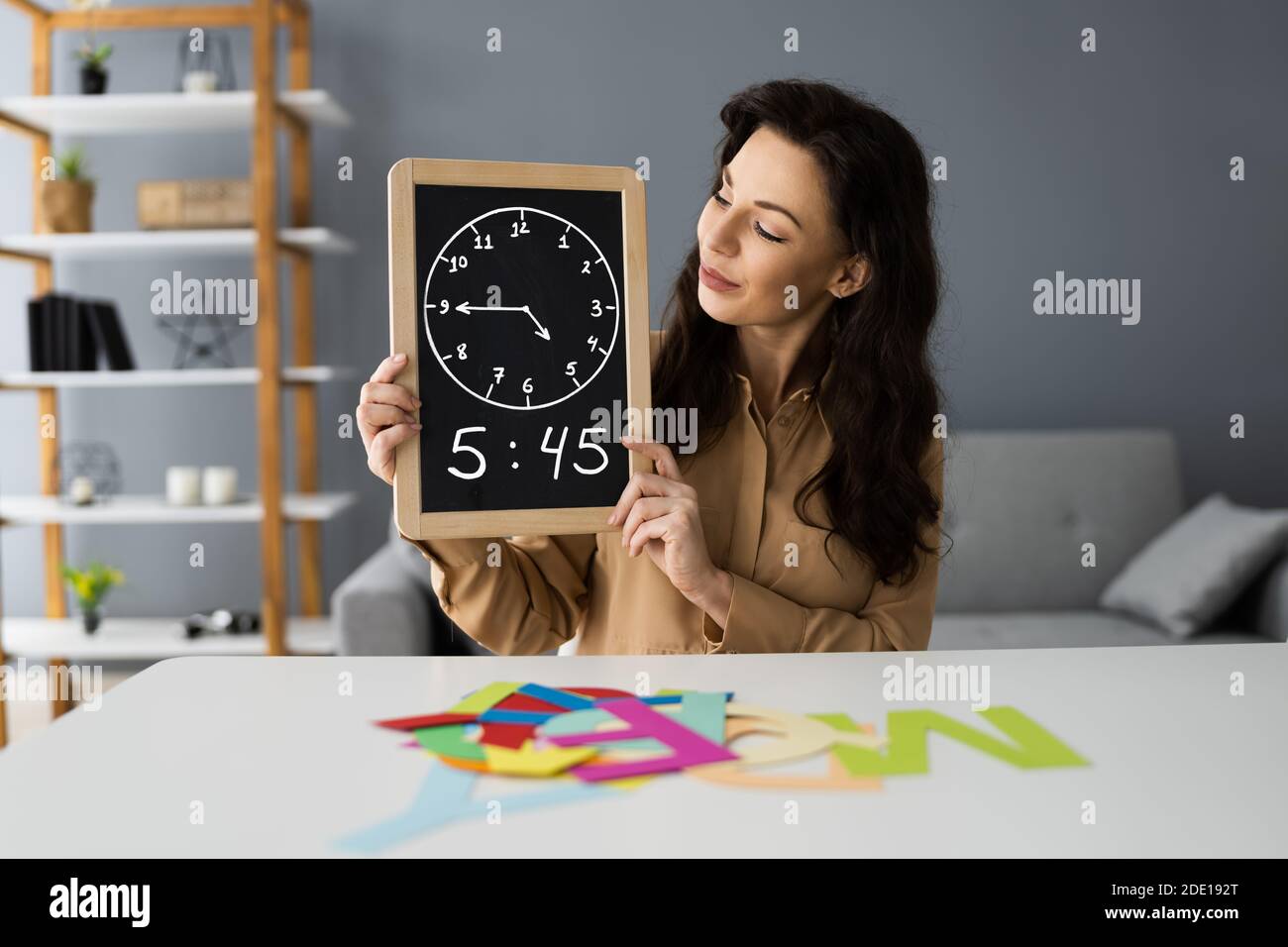 Elementary School Teacher Woman In Video Call Explaining Stock Photo