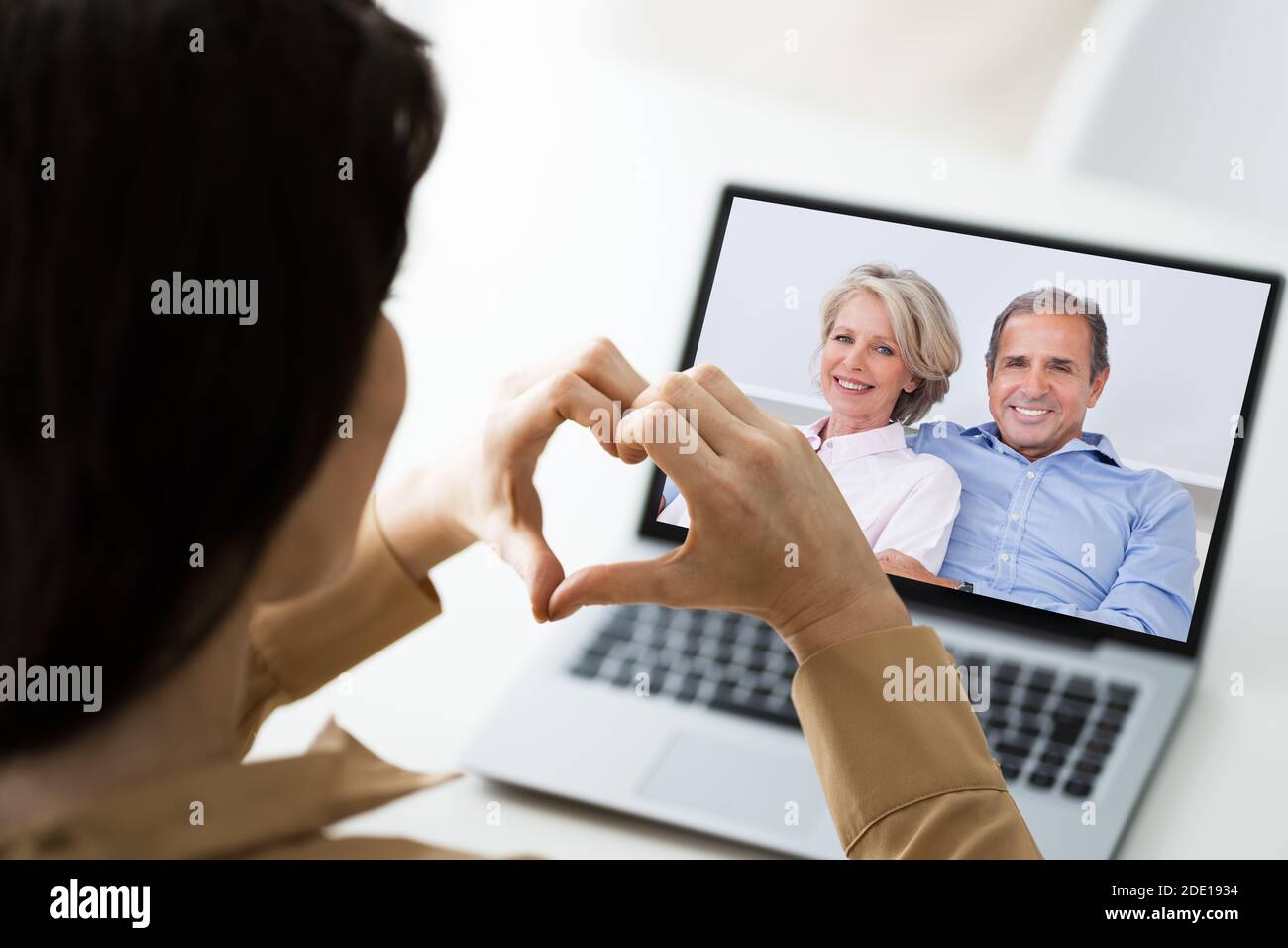 Video Conference Call With Parents On Laptop At Home Stock Photo