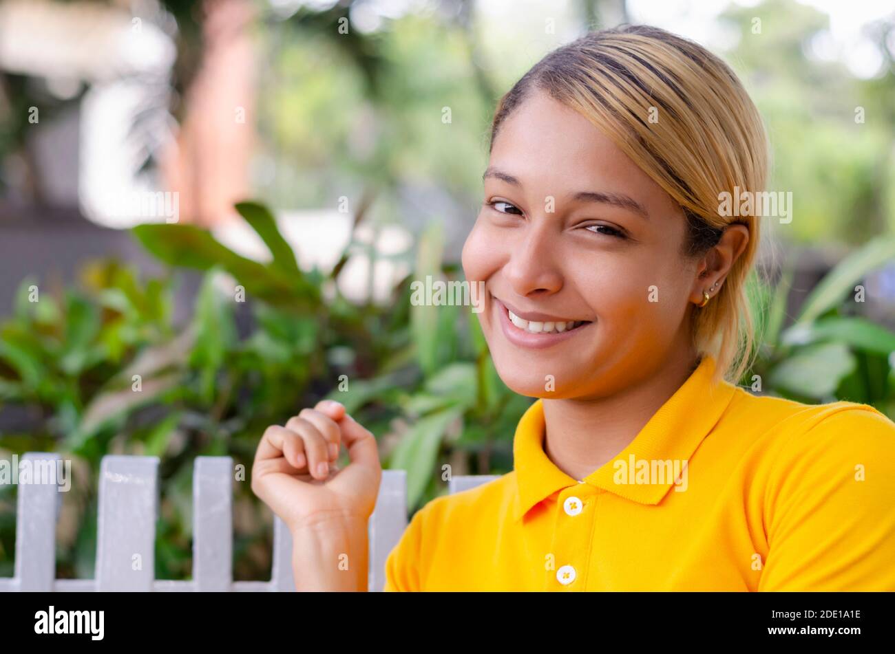 young woman 20 to 30 years in different expressions in front of the camera in a park Stock Photo