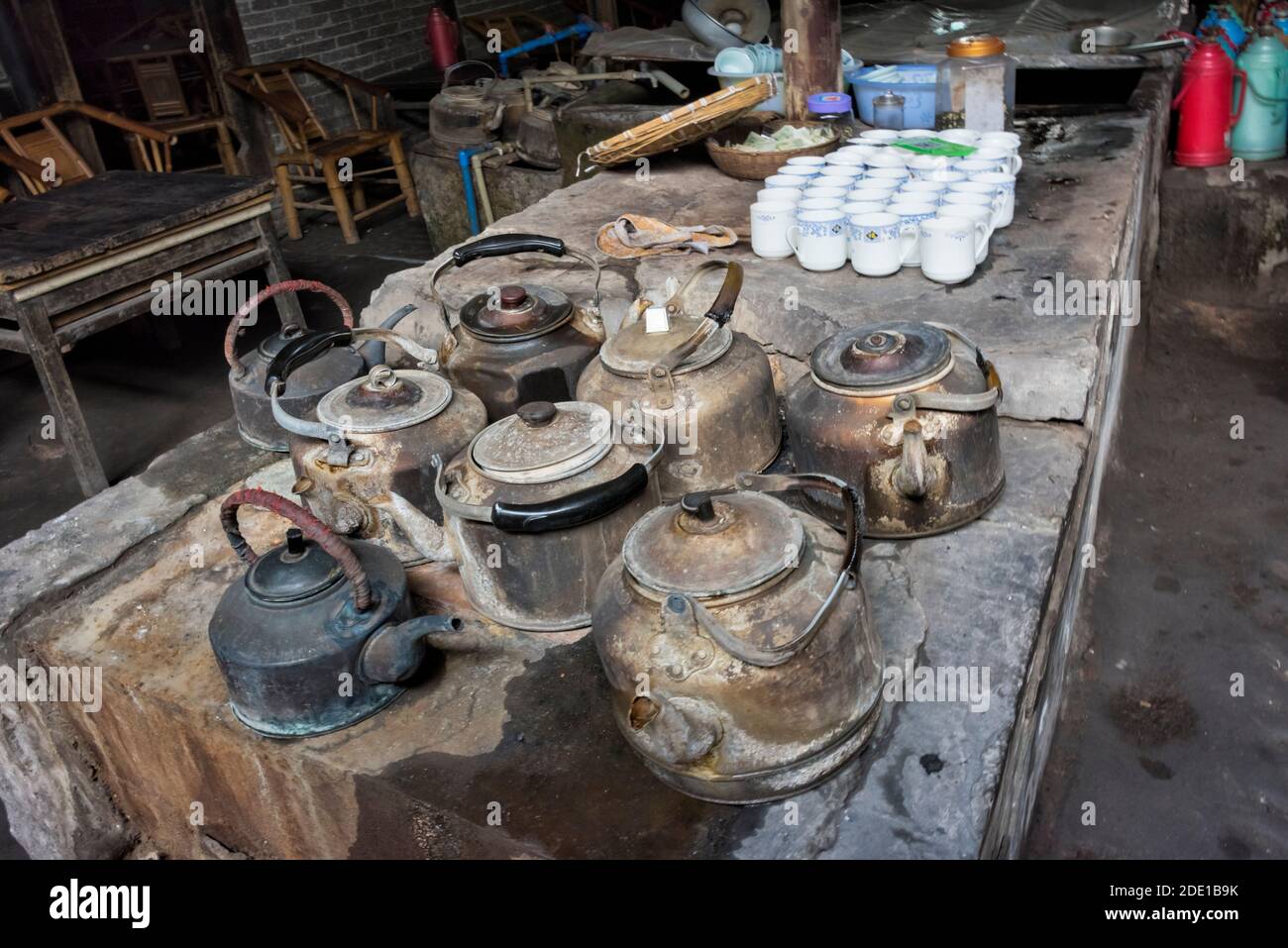 Tea kettles on the stove in an old tea house, Pengzhen, Chengdu, Sichuan Province, China Stock Photo