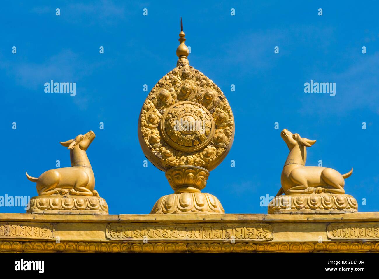 Golden Dharma wheel flanked by two deer on rooftop, Norbulingka, part of the 'Historic Ensemble of the Potala Palace and a UNESCO World Heritage site, Stock Photo