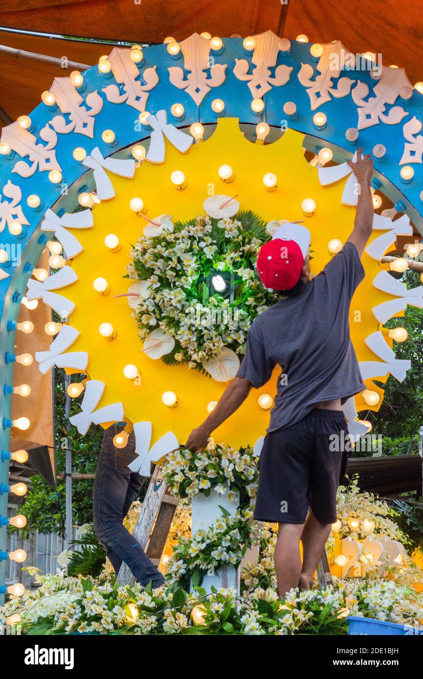 A Filipino man making finishing touches to a festival float to be used during the May Flower Tapusan Festival in Alitagtag, Batangas, Philippines Stock Photo