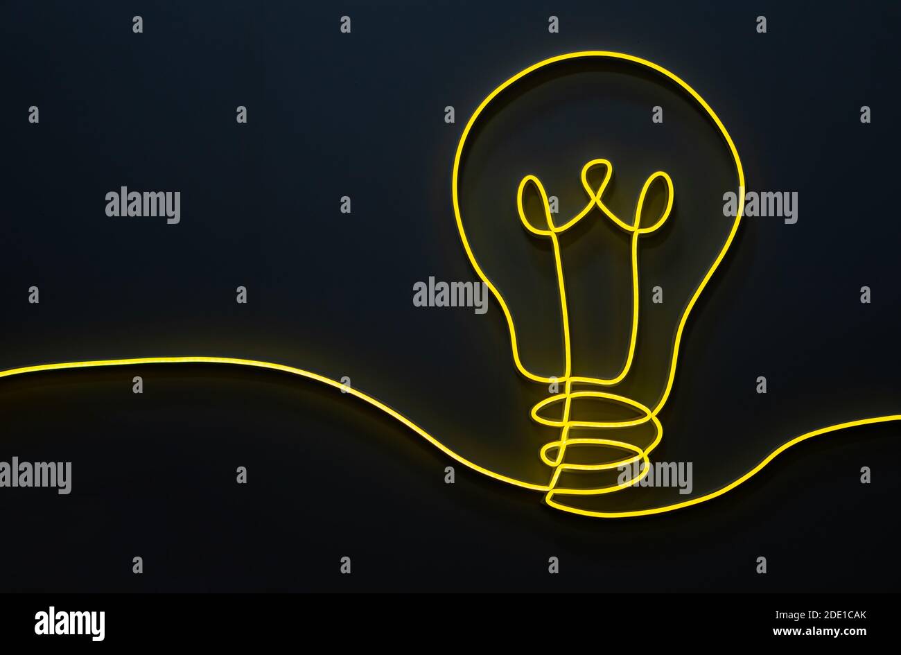 Yellow light bulb shape decoration design made from led light line on a dark background Stock Photo