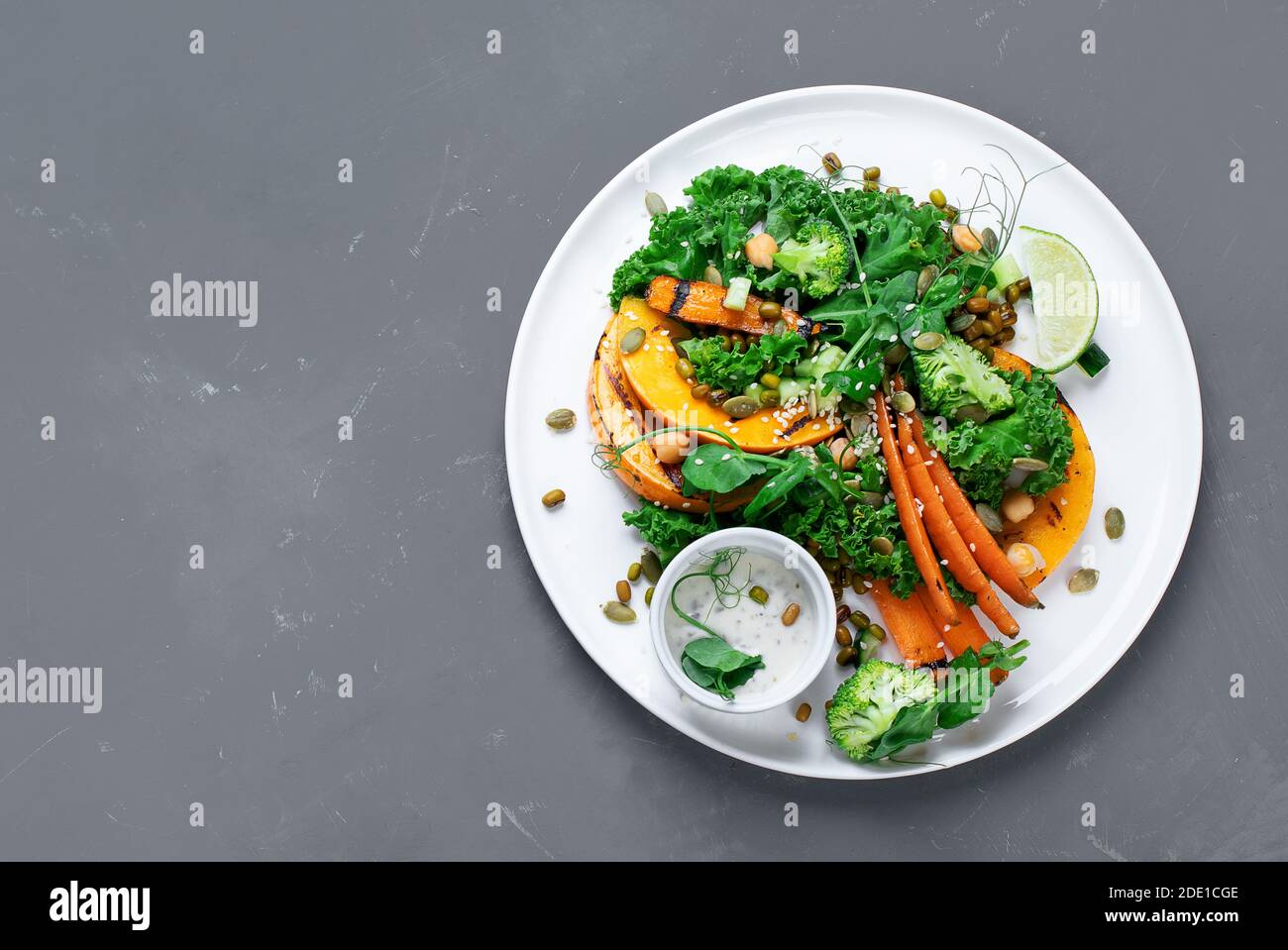 Grilled pumpkin salad with vegetables. Healthy vegan food. Top view, copy space Stock Photo