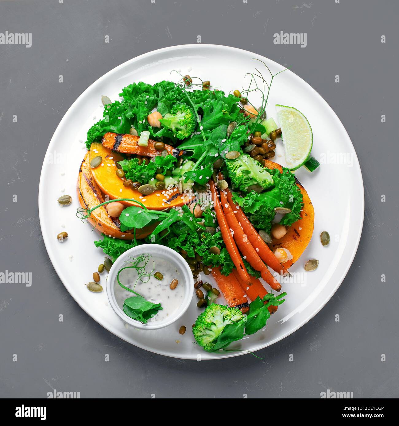 Grilled pumpkin salad with vegetables. Healthy vegan food. Top view Stock Photo