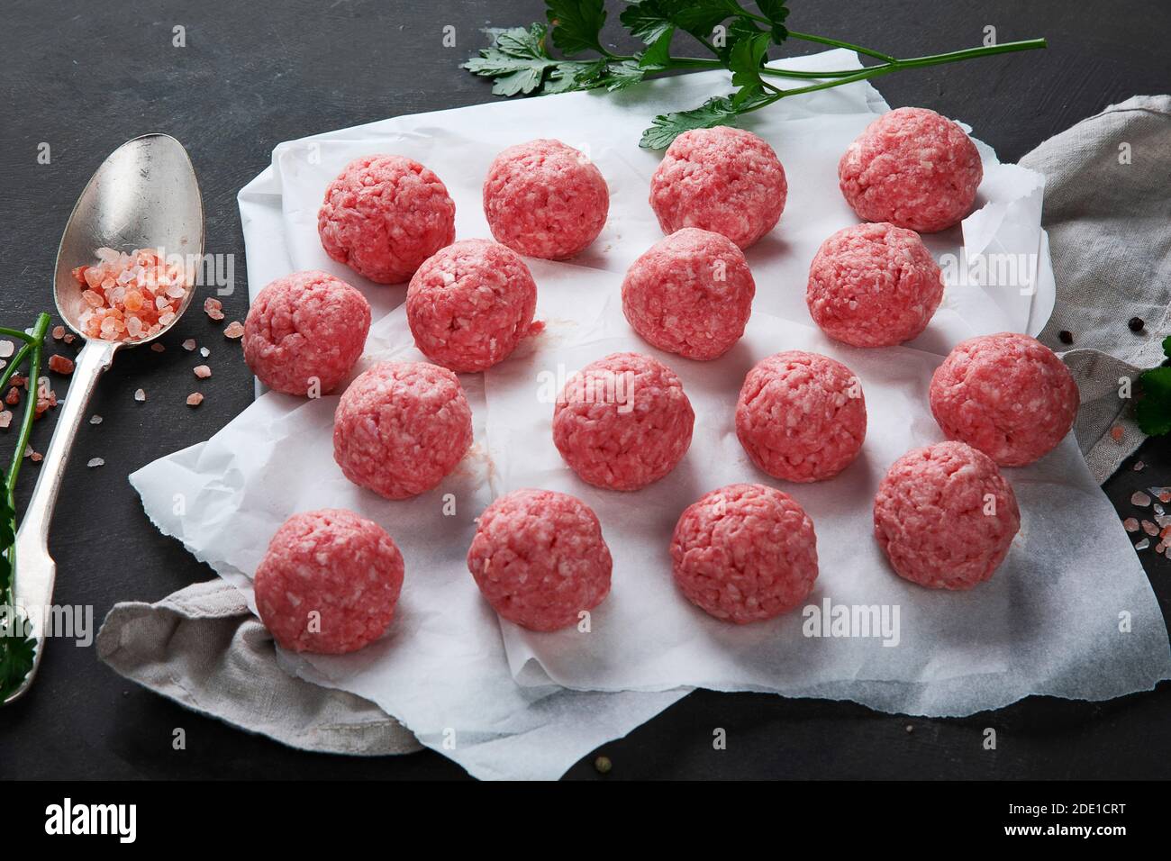 Fresh raw meatballs with herbs. Stock Photo