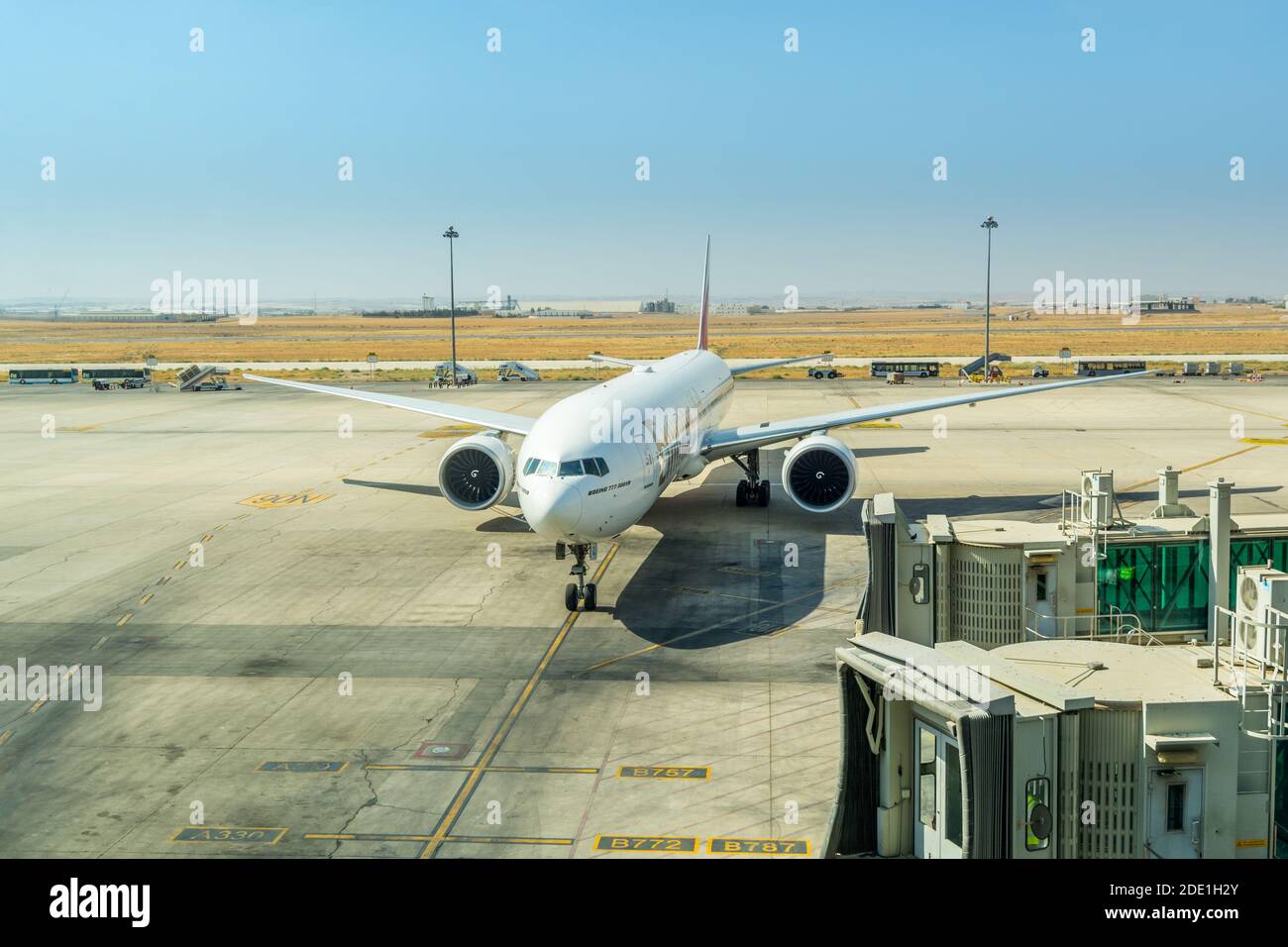 Airplane of Emirates airlines at the boarding gate of Queen Alia