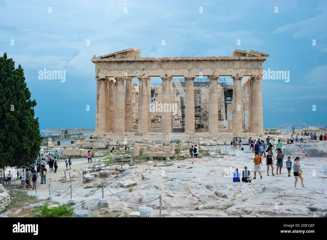 Parthenon temple against stormy sky background and a group of tourists in front of it, Athens, Greece Stock Photo