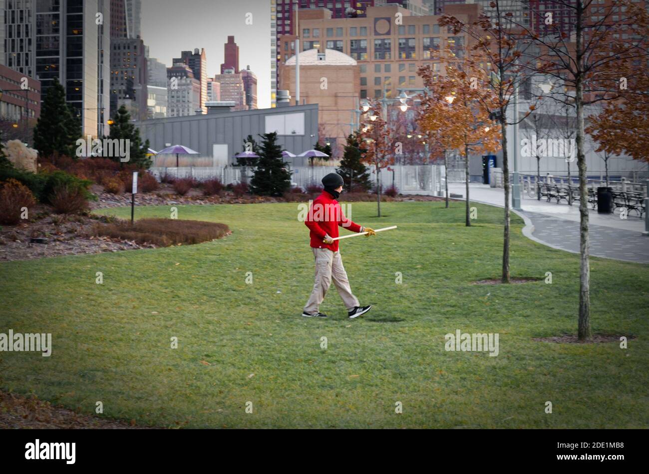 Isolated Man Practicing Martial Arts With a Stick in Lower Manhattan in