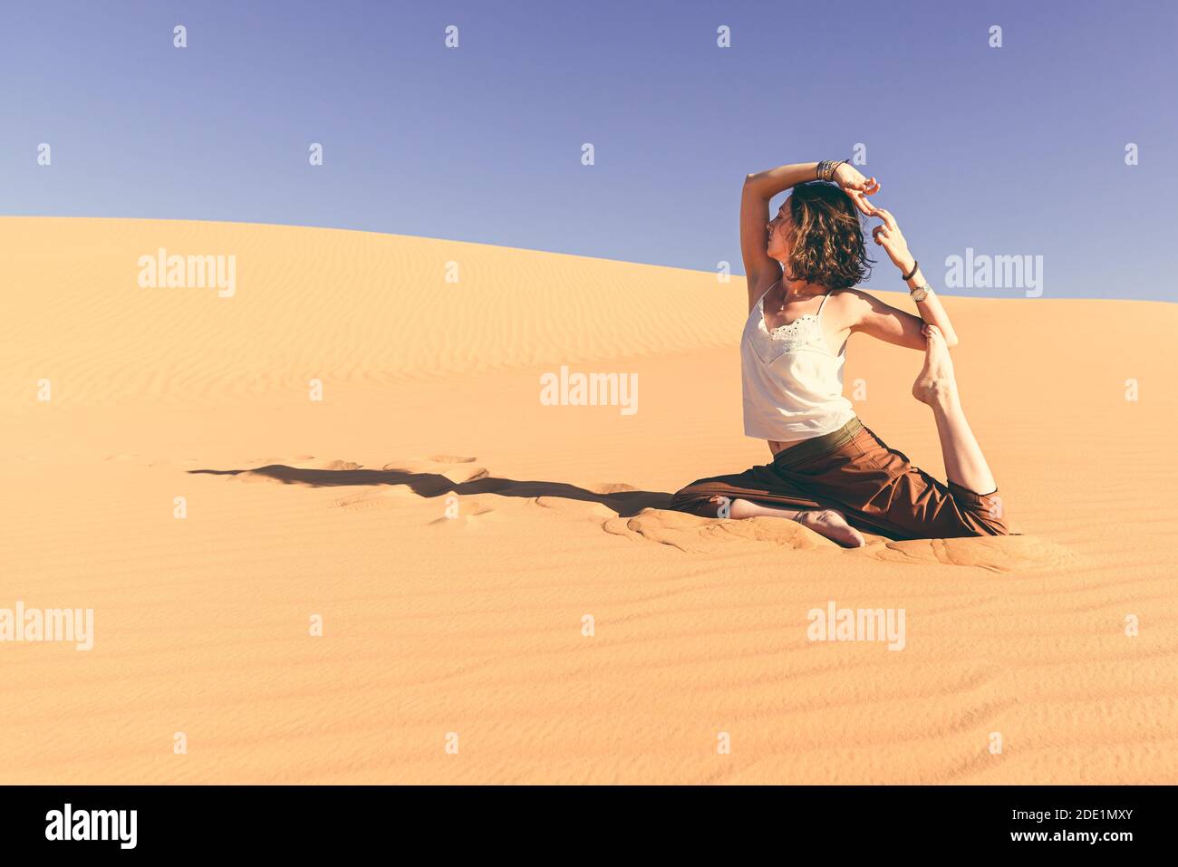 Yoga meditation on the sand dune,healthy female body in peace, woman sitting relaxed on sand, calm girl enjoying nature, active vacation lifestyle, z Stock Photo