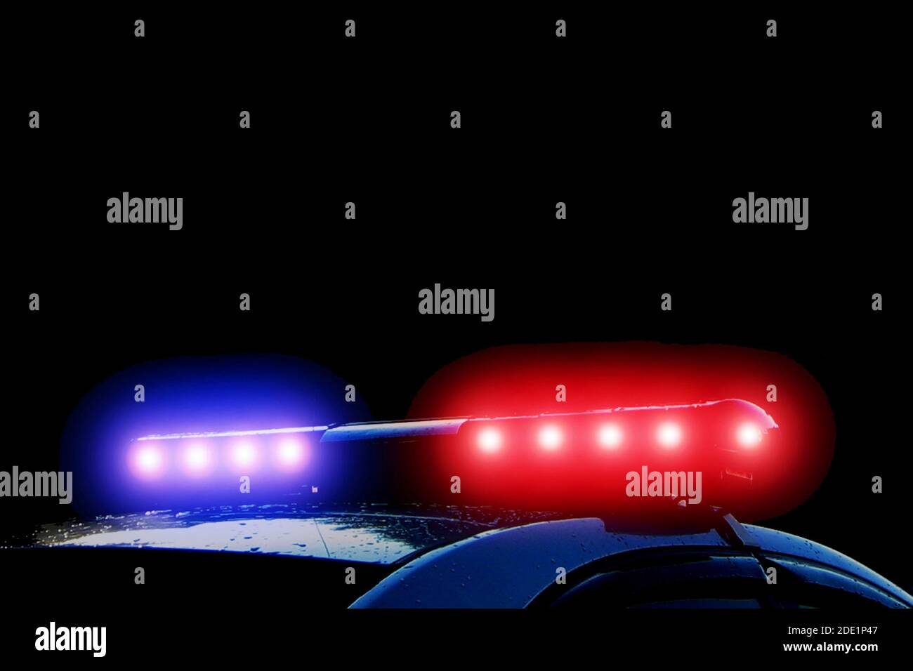 Police car with red and blue flashing lights on street at night time, crime scene. Emergency vehicle lights flashing Stock Photo