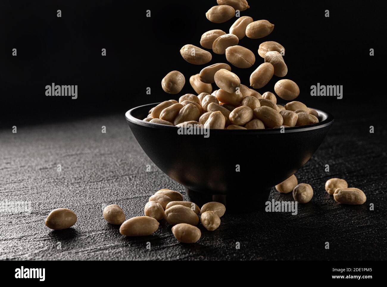 Falling peanut on black background with copy space Stock Photo