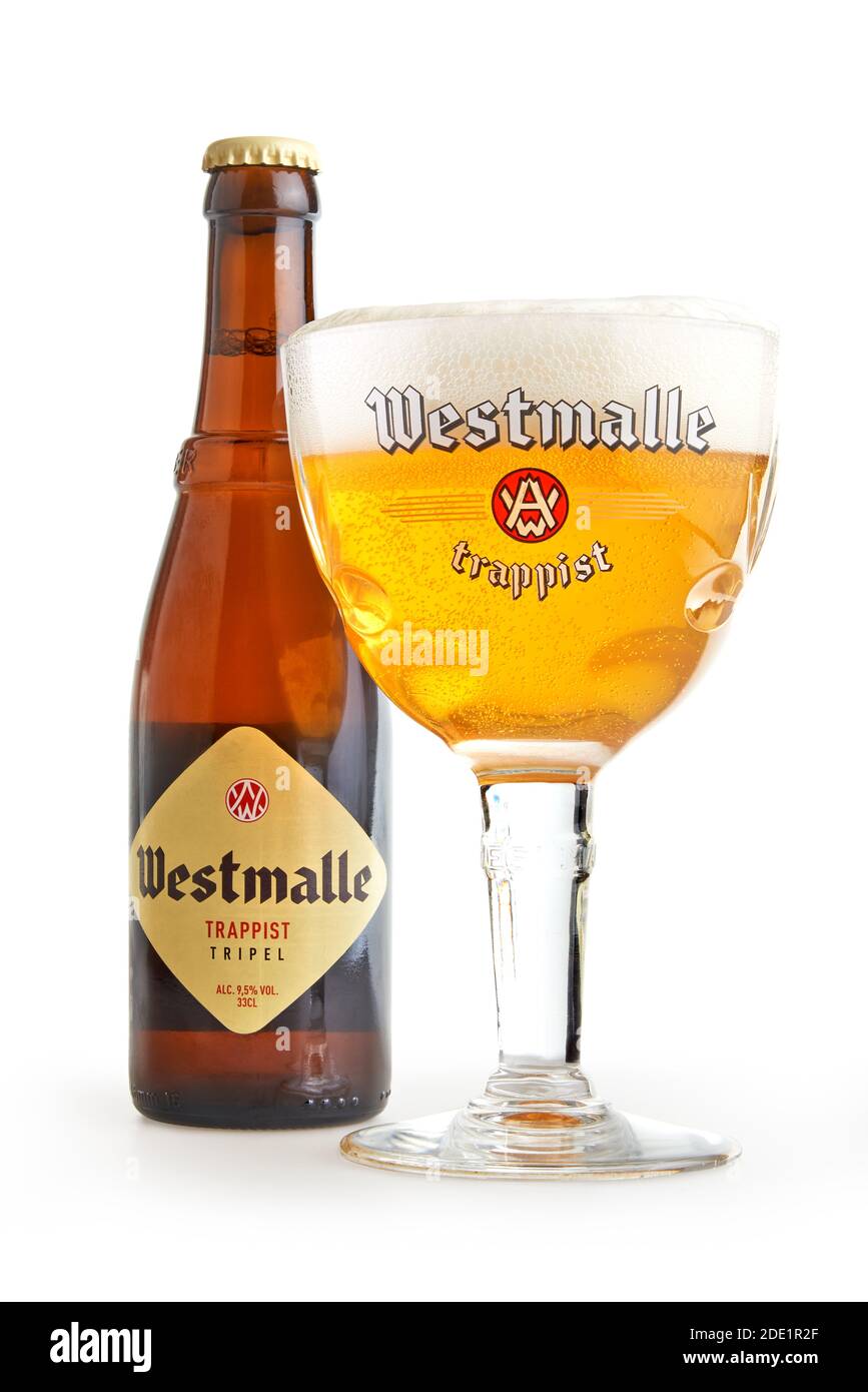 BRUSSELS, BELGIUM - NOVEMBER 27, 2020: Bottle and filled glass of a authentic tripel Westmalle trappist isolated on white Stock Photo