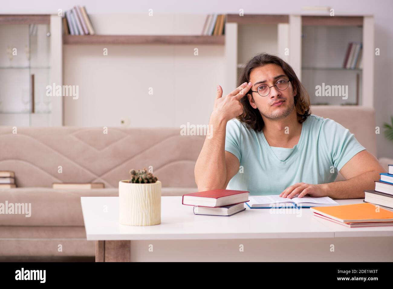 Young student preparing for exams at home Stock Photo - Alamy