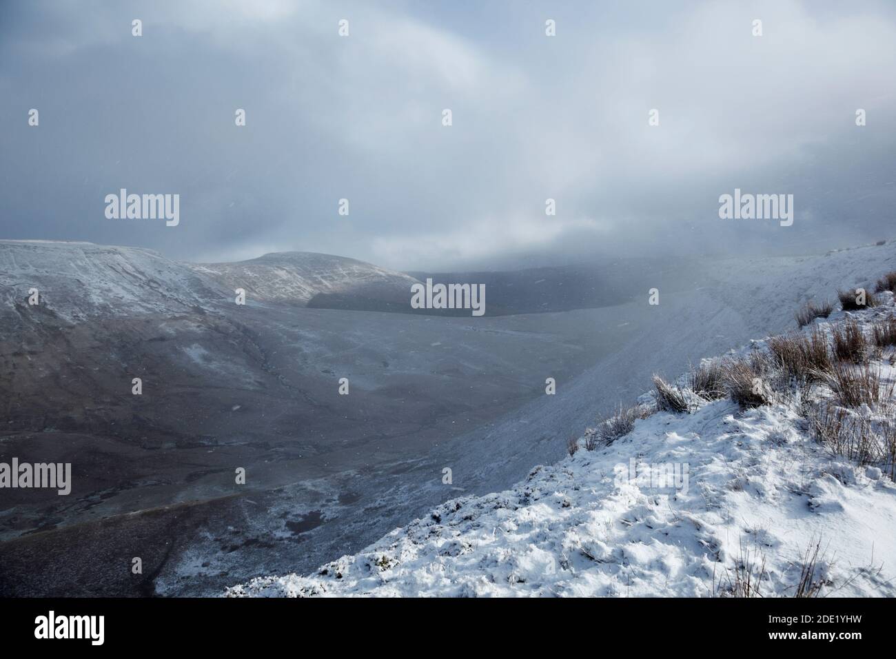 View down the Cerrig Edmwnt valley in clearing snow shower. Brecon Beacons National Park. Wales. UK. Stock Photo