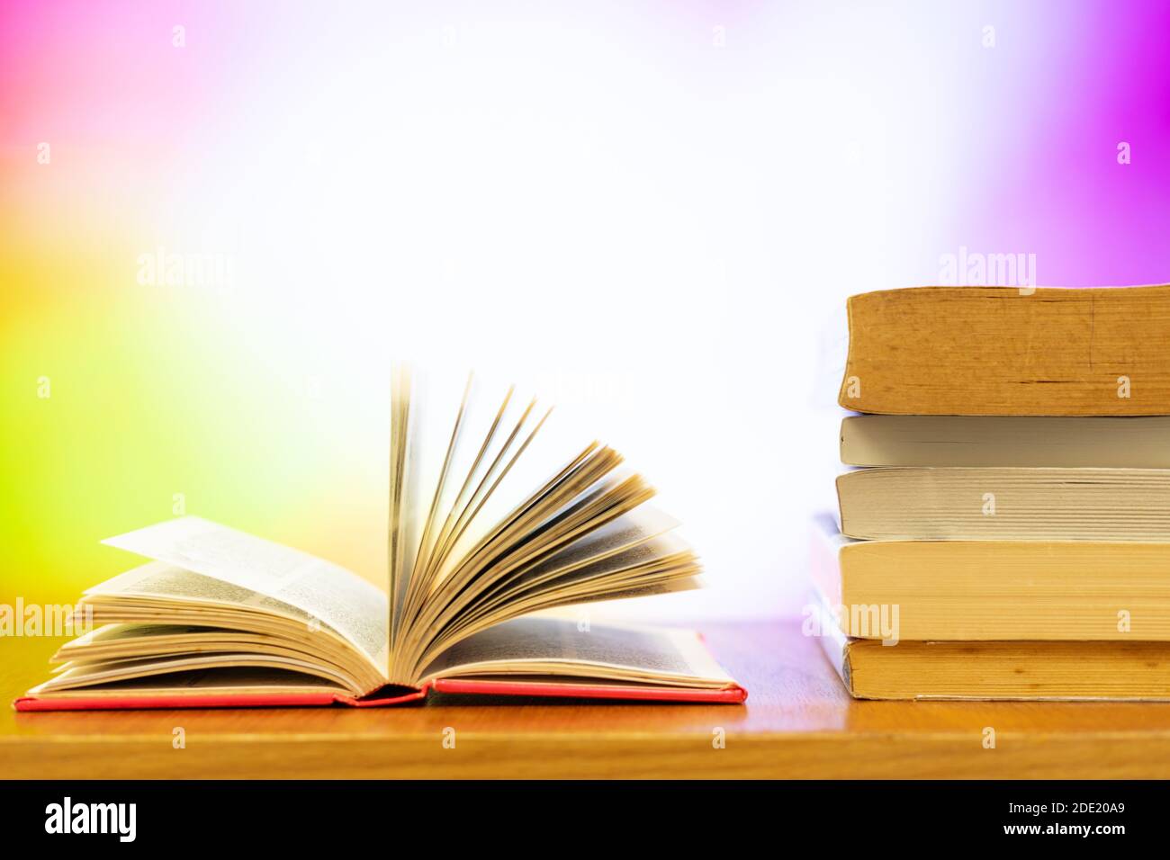 A pile of books and open book with blurred colour as background and copy  space Stock Photo - Alamy
