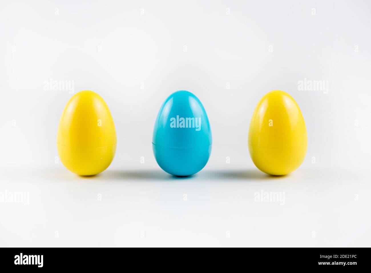 Three Colorful Plastic Easter Eggs on white background. Stock Photo