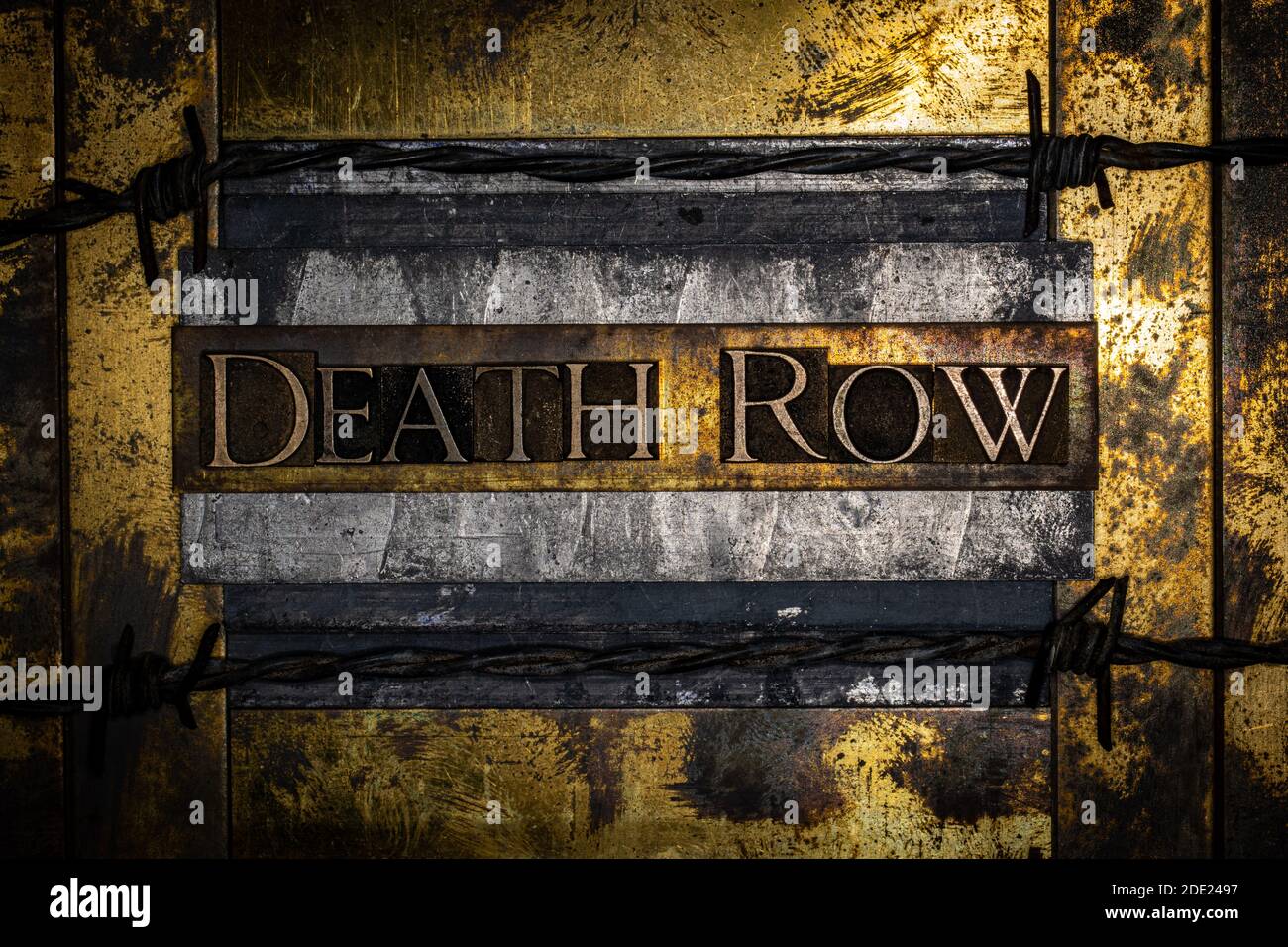 Death Row text lined with barbed wire on grunge lead with textured copper and gold background Stock Photo
