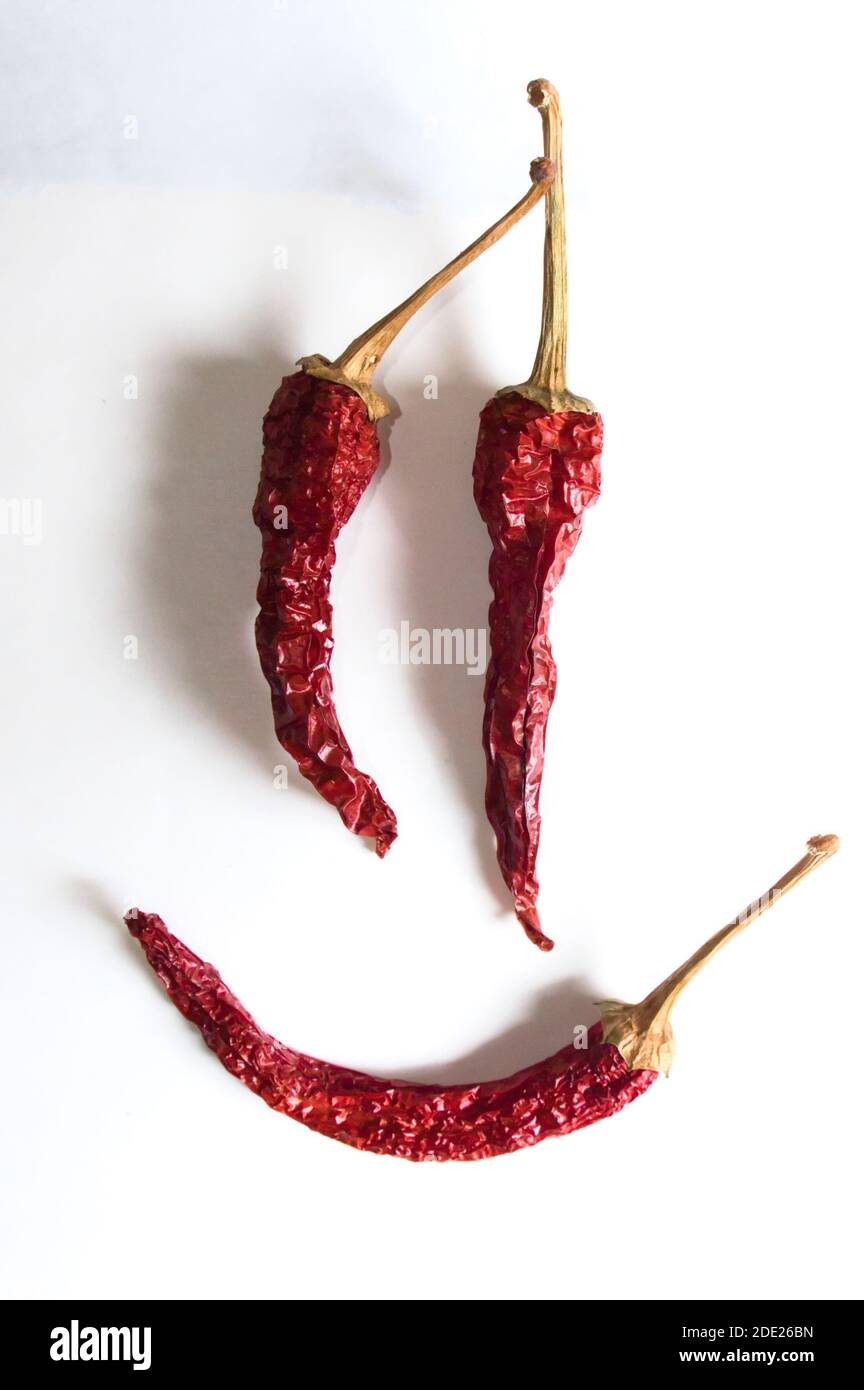 Cheerful emoticon composed of red chili peppers on white background Stock Photo Alamy