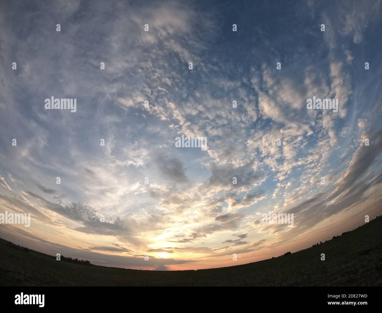 Evening landscape shot with the effect of a fish eye. Dramatic sky. Stock Photo