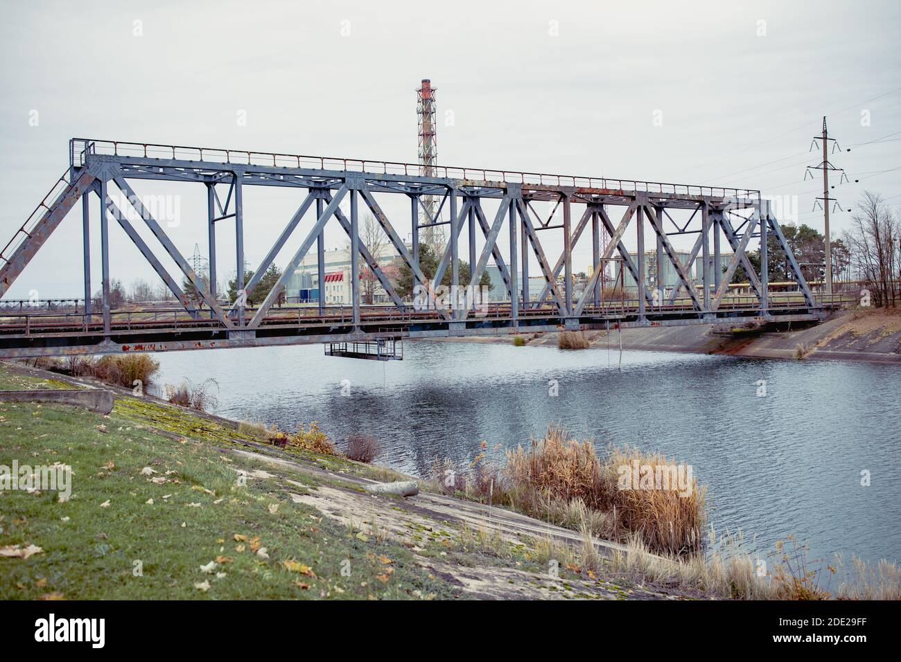 Railway bridge over the Pripyat river, Chernobyl. Metal structure, bridge supports. Bridge, years later, after the Chernobyl nuclear power plant. Ukra Stock Photo
