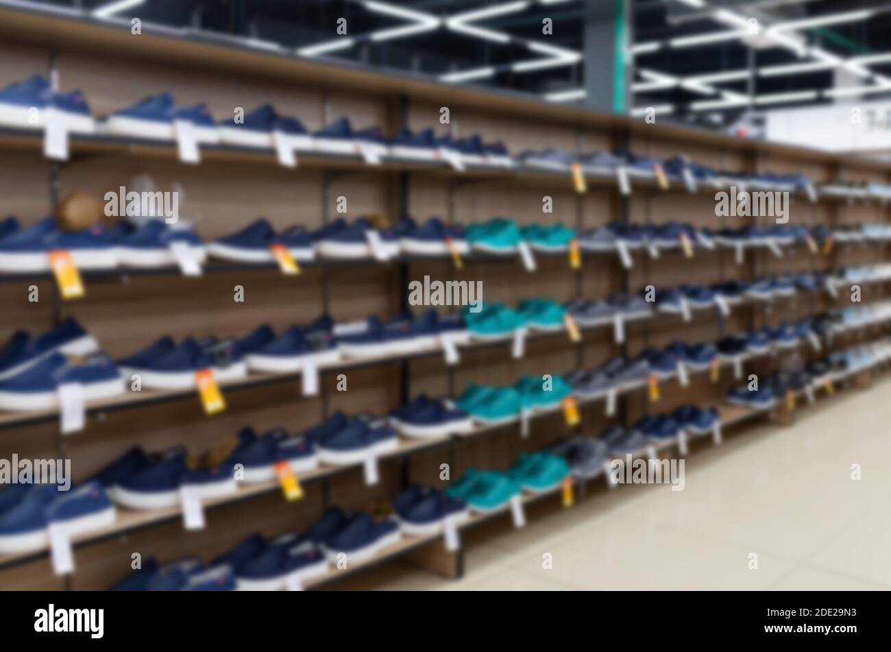 many shoes on the shelves are in the shoe store, blurred and defocused