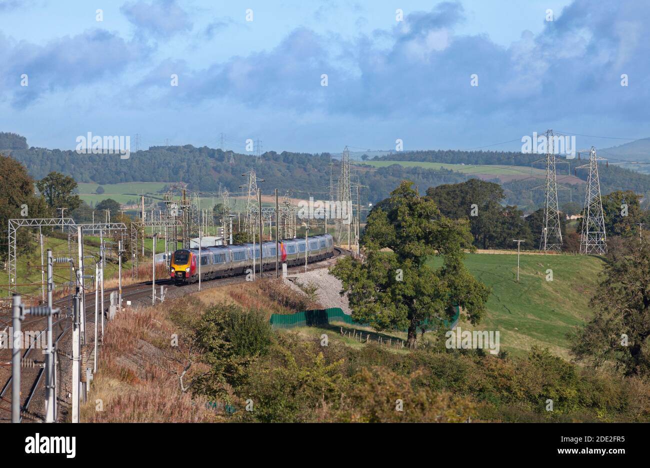 2 Avanti west coast Bombardier class 221 voyager diesel trains on the electrified west coast mainline passing the countryside in Cumbria Stock Photo