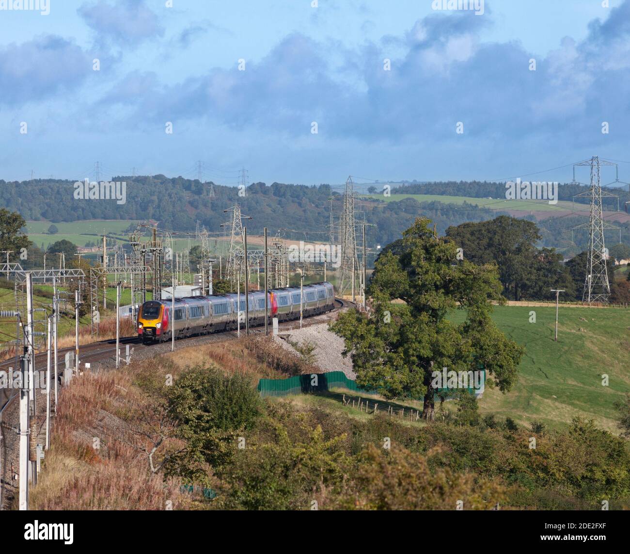 2 Avanti west coast Bombardier class 221 voyager diesel trains on the electrified west coast mainline passing the countryside in Cumbria Stock Photo