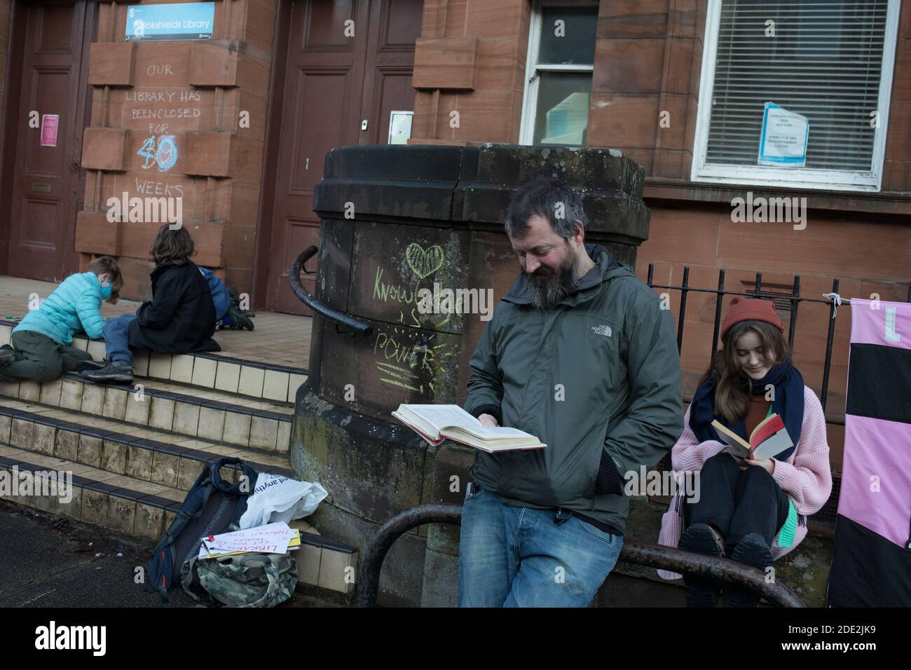 Glasgow, Scotland, UK, 28th November 2020. People campaign to re-open the Pollokshields public library, in the Southside of the city, which have been closed now for 40-weeks. Campaigners maintain the libraries are needed for education, for the mental health benefits and for the wider needs of the city's most diverse local communities, during these unprecedented times of the Covid-19 global health pandemic. It is also feared the the city council will use the temporary closures as a way of keeping the libraries closed permanently. Approximately 20 libraries are currently closed within Glasgow. P Stock Photo