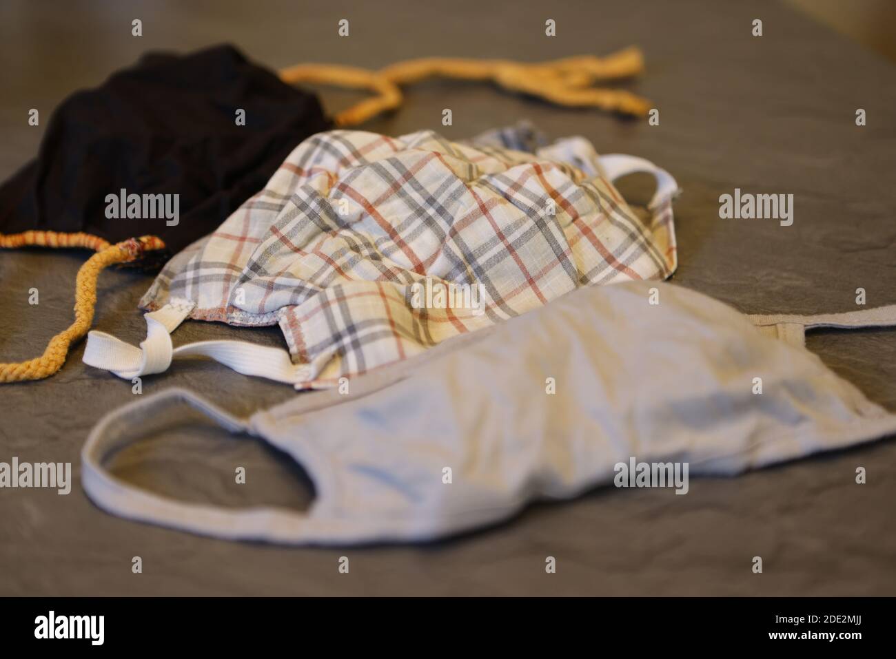 Corona Pandemic: Different Facemasks lying on a table Stock Photo