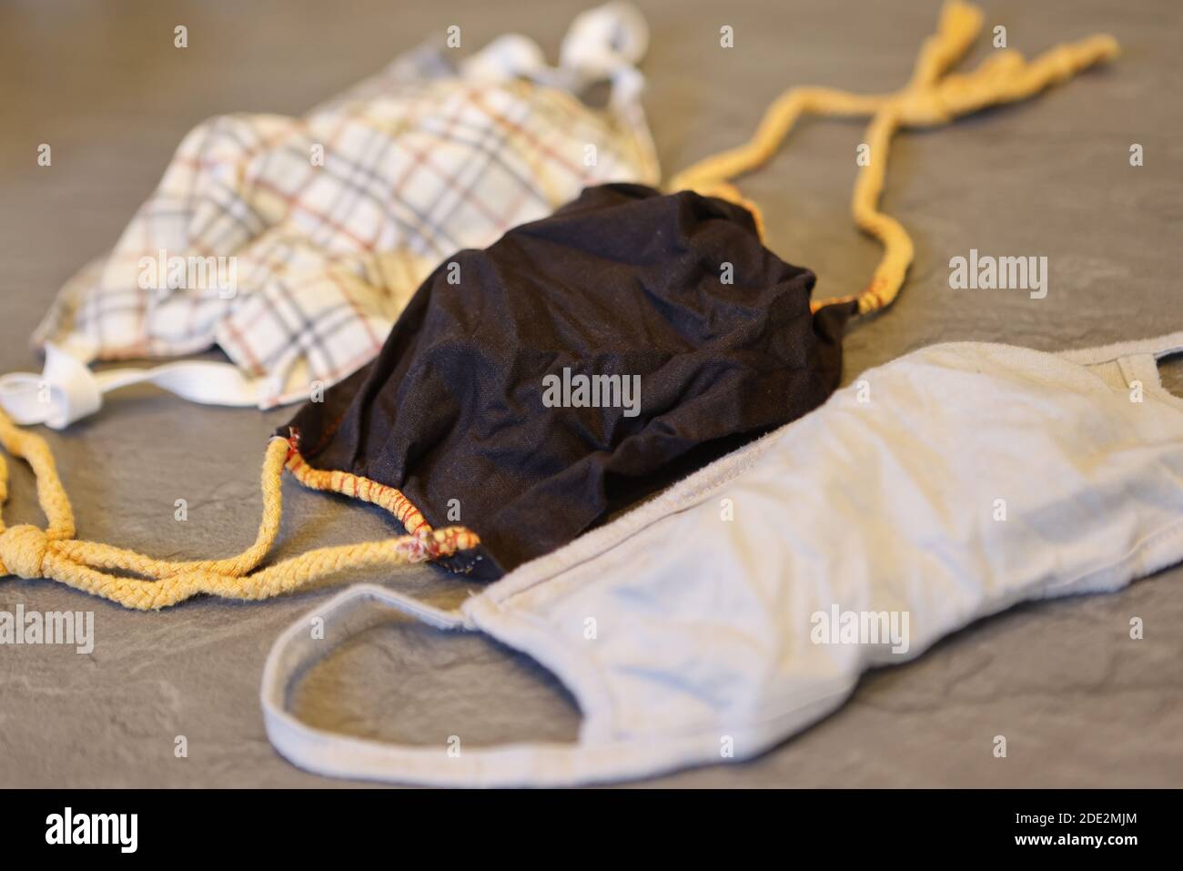 Corona Pandemic: Different Facemasks lying on a table Stock Photo