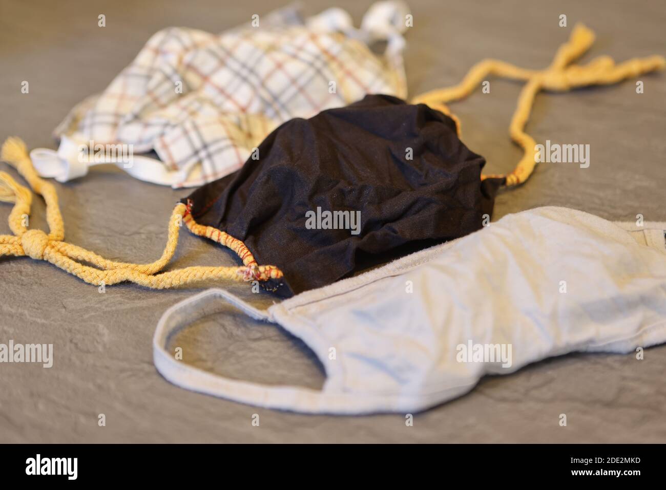 Corona Pandemic: Different Facemasks lying on a table Stock Photo