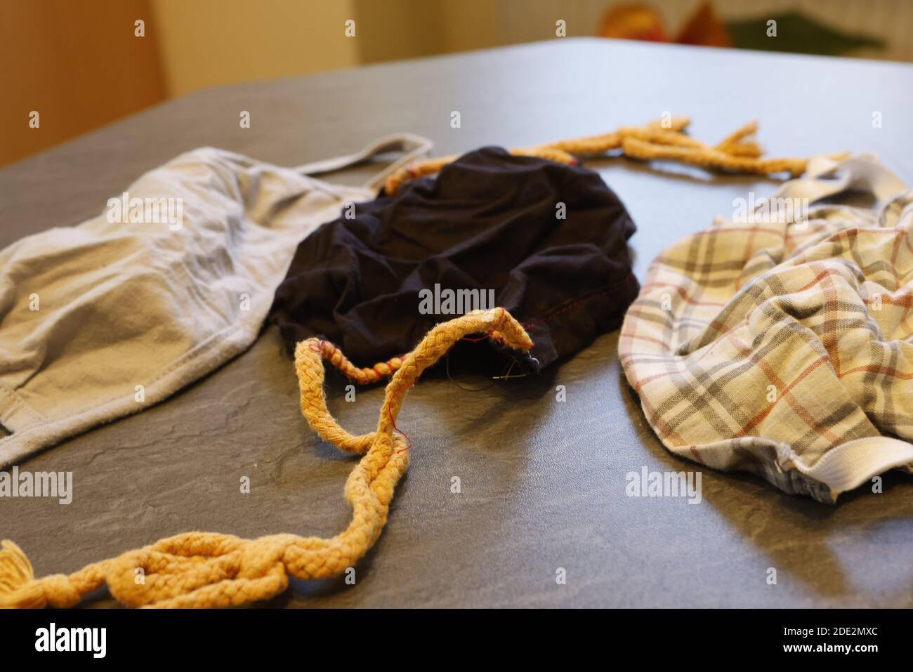 Corona Pandemic: Different Facemasks lying on a table Stock Photo
