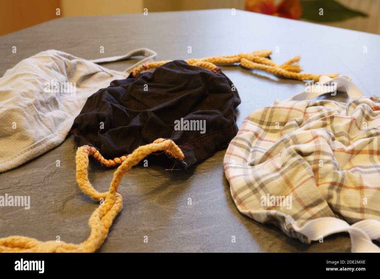 Corona Pandemic: Different Facemasks lying on a table Stock Photo